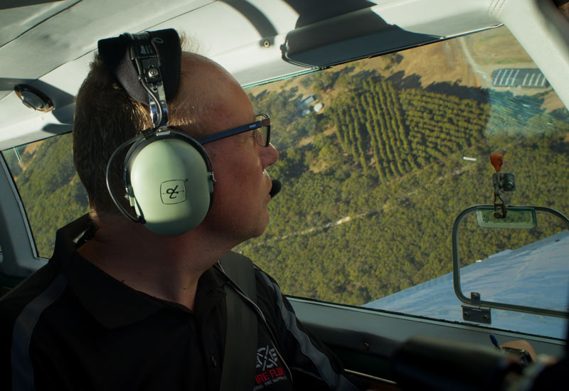 Dr Paul Dare in plane surveying landscape