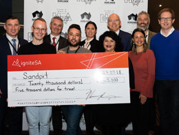 Group of people holding a cheque